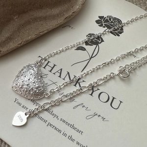 925 sterling silver heart necklace with textured pendant on a thank you gift card