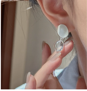 Detail of S925 silver matte earrings with clear beads on earlobe close-up view