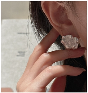 Detailed close-up of S925 sterling silver flower earring with fine brushed texture finish