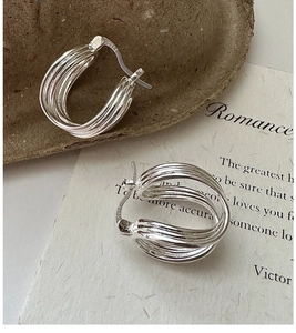 Detailed macro view of S925 sterling silver multi-layer curved hoop earrings with hallmark