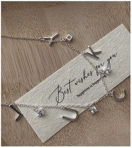 Macro shot of S925 silver LUCKY letter necklace with sparkling zircon stone details