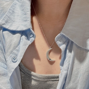 925 silver crescent moon necklace with zircon stone on model with blue shirt