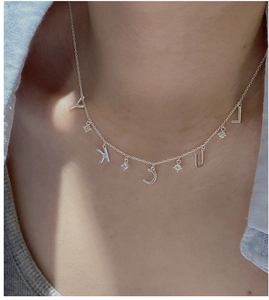 Detailed view of S925 silver LUCKY letter necklace with small zircon accents on collarbone