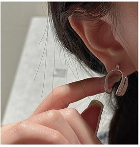 Close-up of minimalist S925 sterling silver U-shaped double hoop earrings on model