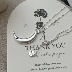 Minimalist 925 sterling silver crescent moon necklace with a matte finish and black zircon