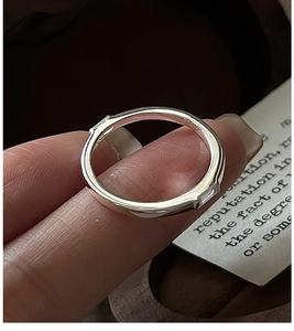 Macro shot of minimalist S925 silver ring featuring rectangular bezel-set cubic zirconia