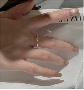 Close-up of minimalist S925 sterling silver ring with rectangular zircon on hand
