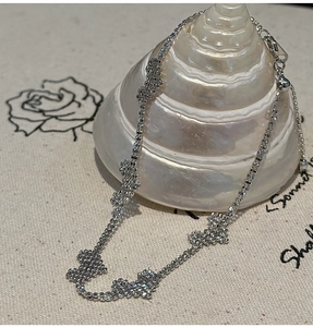 Detail of S925 silver beaded bracelet with clover motifs and adjustable slider clasp