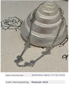 Detail of S925 sterling silver heart bracelet with size 16+3cm on a spiral shell