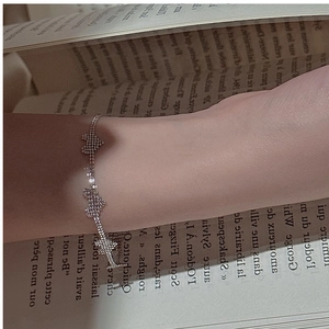 Detail of S925 sterling silver heart bracelet with sparkling stones on a model wrist