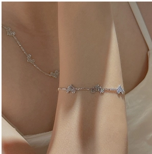 Close-up of minimalist S925 sterling silver laser heart bracelet worn by a model