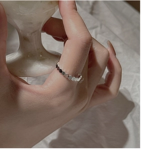 Macro shot of silver S925 ring featuring a modern geometric honeycomb hexagon pattern
