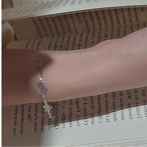 Detailed view of S925 silver bracelet featuring three heart charms set with sparkling stones