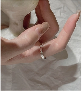 Macro shot of S925 sterling silver ring with geometric honeycomb texture on a model's finger