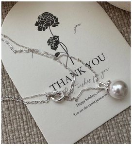Close-up of S925 silver double-layered necklace with large white shell pearl pendant