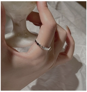 Close-up of minimalist S925 sterling silver honeycomb ring on female hand model