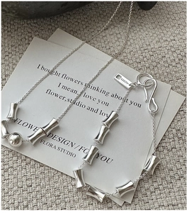 Macro detail of S925 sterling silver bamboo joint chain necklace with AG925 hallmark