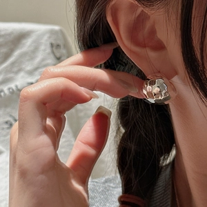 Polished S925 sterling silver hammered texture dome earrings shown on a model