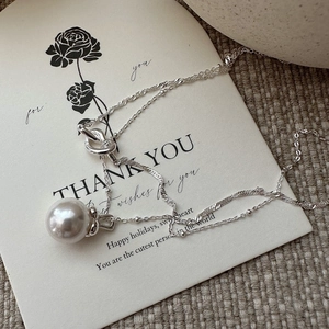 S925 sterling silver double-layer pearl necklace with a minimalist knot pendant design