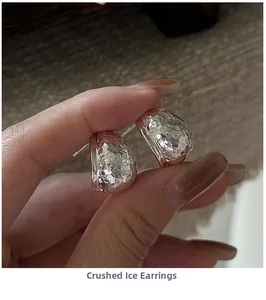 Macro detail of silver S925 earrings with crushed ice texture and geometric facets