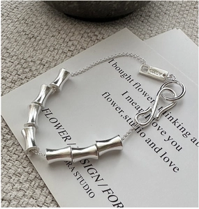Detailed macro shot of 925 sterling silver bamboo style bracelet with AG925 hallmark tag