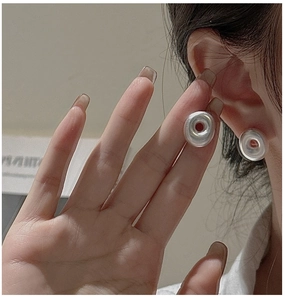 Close-up of minimalist S925 sterling silver hollow hoop earrings on model ear