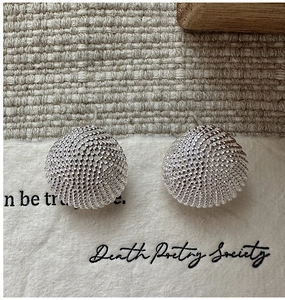 Macro detail of S925 sterling silver stud earrings with a woven mesh texture design