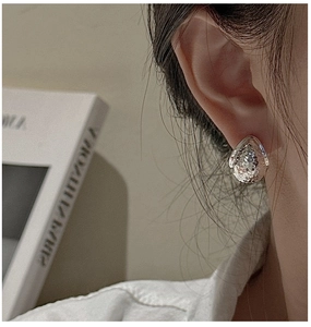 Close-up of S925 sterling silver drop earrings with hammered texture on earlobe