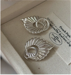 Detail view of S925 sterling silver hollow earrings with shell fold texture in jewelry box