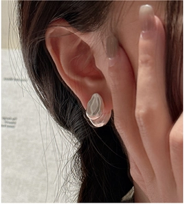 Close-up of S925 sterling silver water drop earring with a matte vintage liquid metal finish