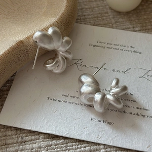 Matte silver 925 sterling silver hollow hoop earrings with modern twisted design
