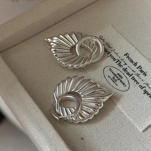 Elegant S925 sterling silver hollow earrings with radial texture in a jewelry box