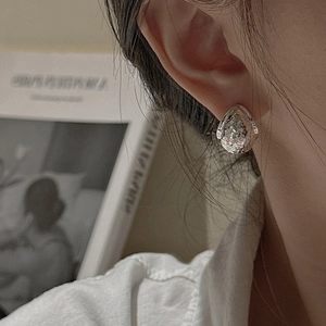 S925 sterling silver teardrop earrings with hand-hammered texture shown on model