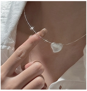 Close-up of minimalist S925 sterling silver heart pendant choker worn on neck