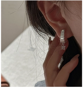 Close-up of S925 sterling silver hoop earrings with textured finish and square zircon drop