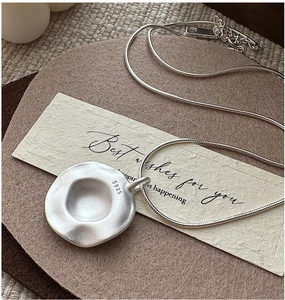 Detail of S925 sterling silver necklace showing the hallmark and matte pendant finish