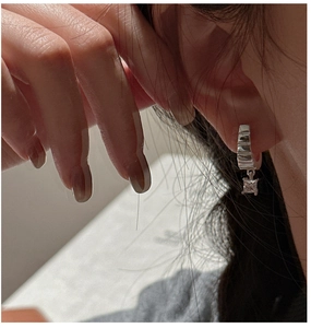 Close-up of S925 sterling silver hoop earrings with square zircon stone on ear