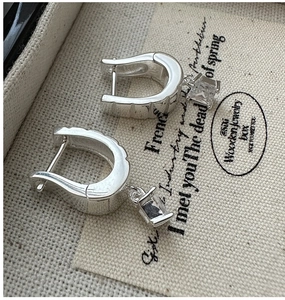 Detailed macro view of S925 silver U-shaped earrings with square-cut sparkling zircon