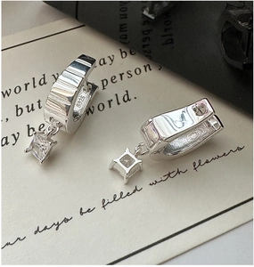 Detailed close-up of S925 sterling silver hoop earrings with sparkling zircon pendants
