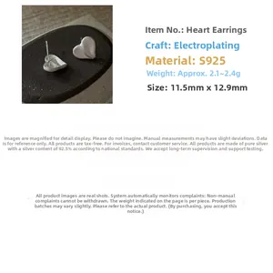 Macro shot of S925 sterling silver heart studs with a brushed matte finish and metal texture