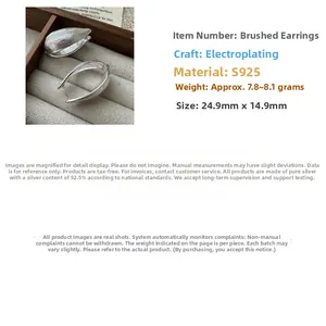 Detail view of S925 sterling silver hoop earrings featuring a brushed metal texture finish