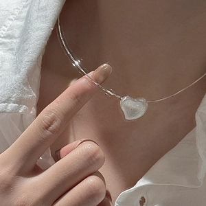 S925 sterling silver minimalist choker necklace with a textured heart pendant on a model
