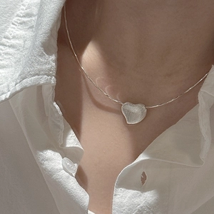 Minimalist S925 sterling silver heart necklace with a brushed matte finish on a model
