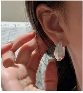 Detailed macro view of S925 sterling silver petal earrings with matte brushed texture