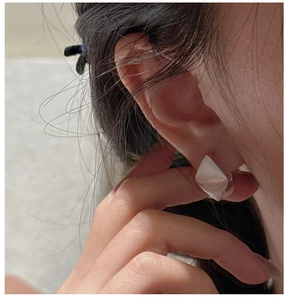 Macro shot of S925 sterling silver geometric rhombus earrings with brushed matte finish
