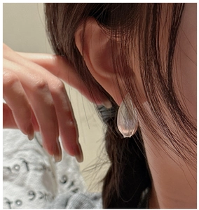 Close-up of S925 sterling silver leaf earring with brushed metal texture on a model
