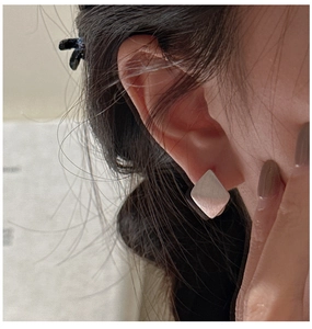 Close-up of S925 sterling silver geometric rhombus earrings with a brushed metal finish