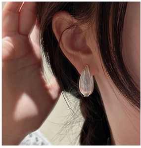 Close-up of S925 sterling silver hoop earrings with brushed texture on female model