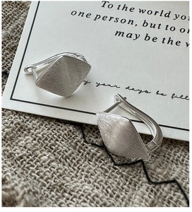 Close-up of S925 sterling silver rhombic hoop earrings with a brushed metal texture finish