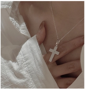 Close-up of a brushed S925 silver cross pendant necklace with a center zircon stone
